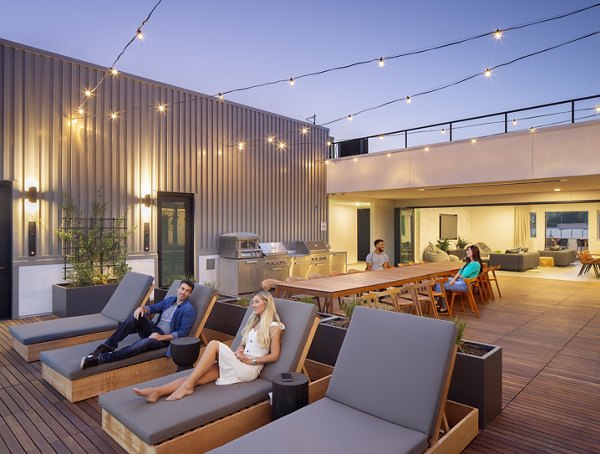 Patio featuring stylish outdoor seating and greenery at Rinrose Apartments