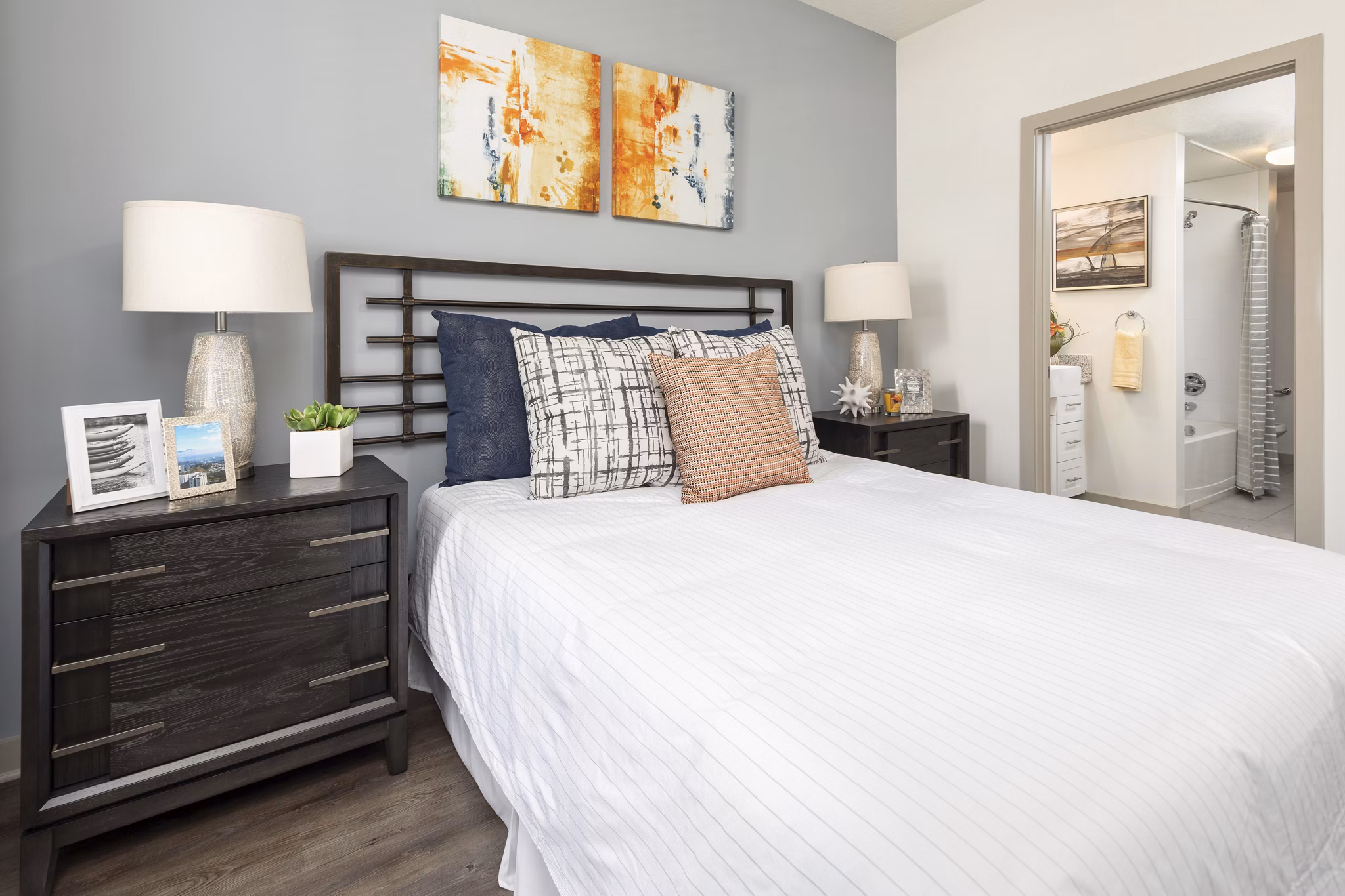 Cozy bedroom with modern decor and ample natural light at Solara Apartments