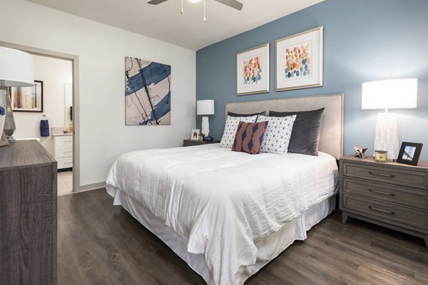 Bedroom featuring modern design and ample natural light at Solara Apartments
