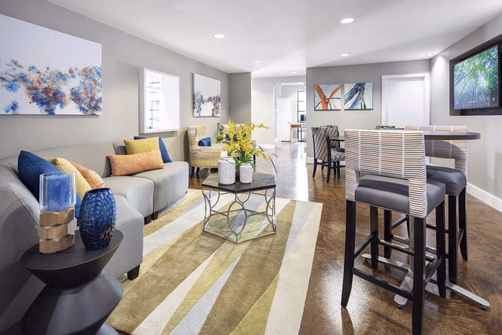 Spacious living room with modern decor and large windows in Solara Apartments