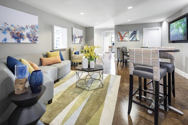 Spacious living room with modern decor and large windows in Solara Apartments