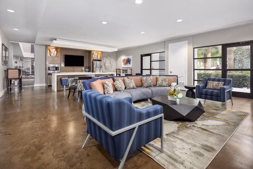 Spacious living room with modern decor and large windows at Solara Apartments, Las Vegas