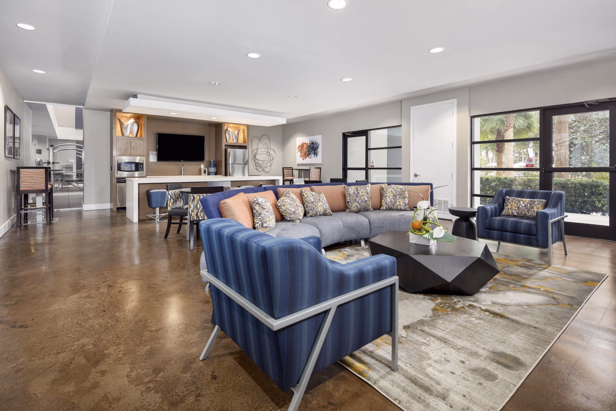 Spacious living room with modern decor and large windows at Solara Apartments, Las Vegas