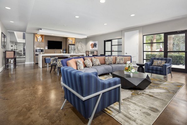 Spacious living room with modern decor and large windows at Solara Apartments, Las Vegas