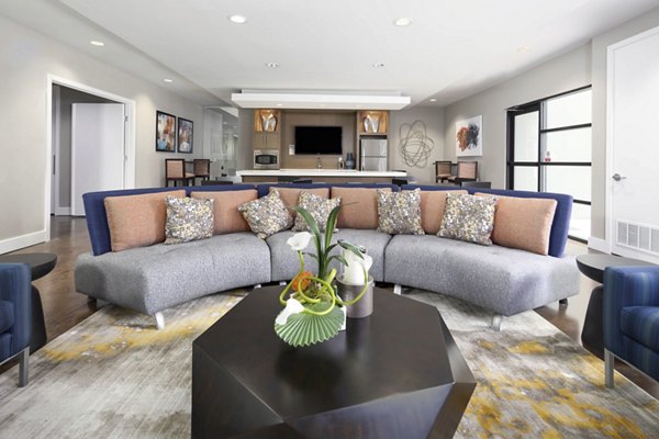 Living room with modern decor and large windows at Solara Apartments