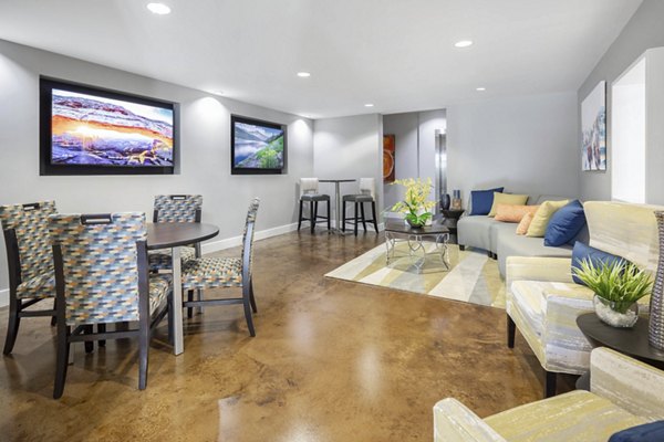 Spacious living room featuring modern dÃ©cor and large windows in Solara Apartments