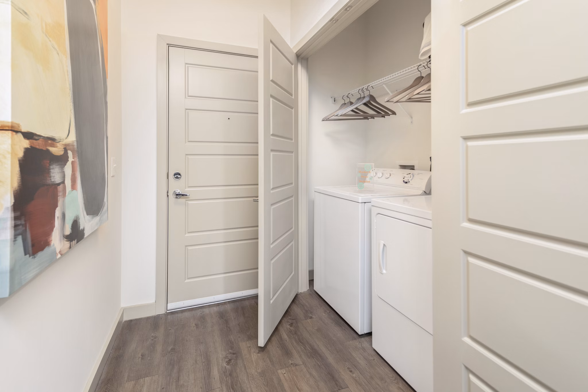 Laundry room with high-efficiency washers and dryers in Solara Apartments, Greystar luxury apartments