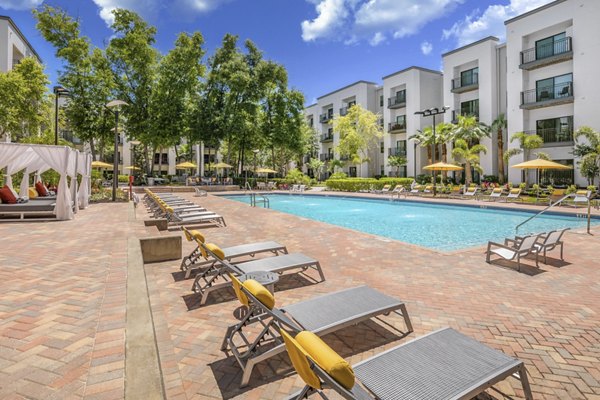 Resort-style pool with sun loungers at Solara Apartments offering luxury living experiences