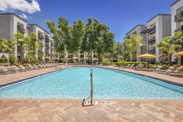 Resort-style pool with sun loungers at Solara Apartments offering luxury living in sunny Phoenix