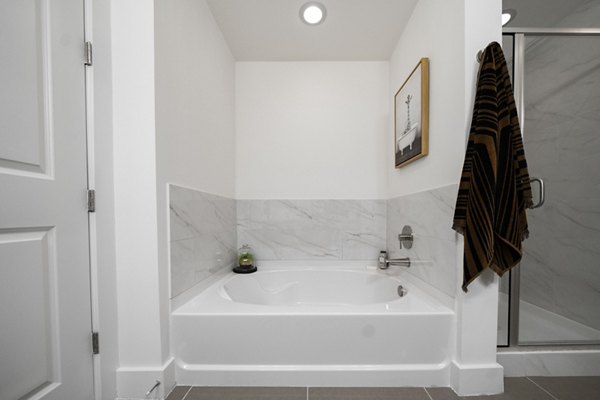 Bathroom featuring modern fixtures and elegant design at Tens on West Apartments