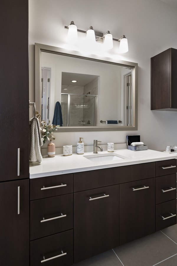 Bathroom with sleek fixtures and modern design at Tens on West Apartments