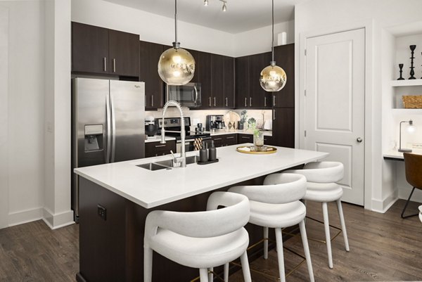 Dining room featuring elegant furnishings and modern lighting at Tens on West Apartments