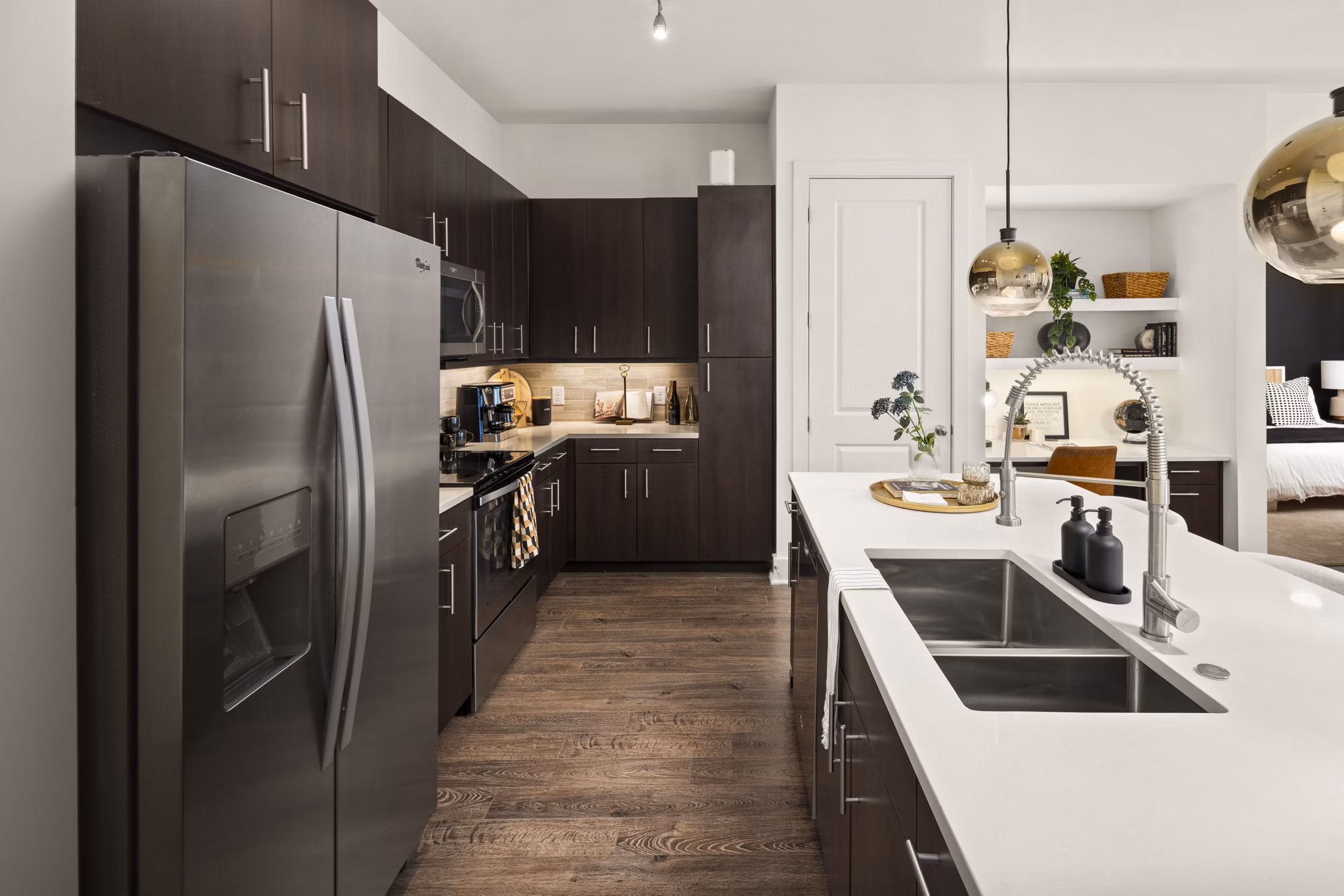 Modern kitchen with stainless steel appliances at Tens on West Apartments, a luxury living space by Greystar