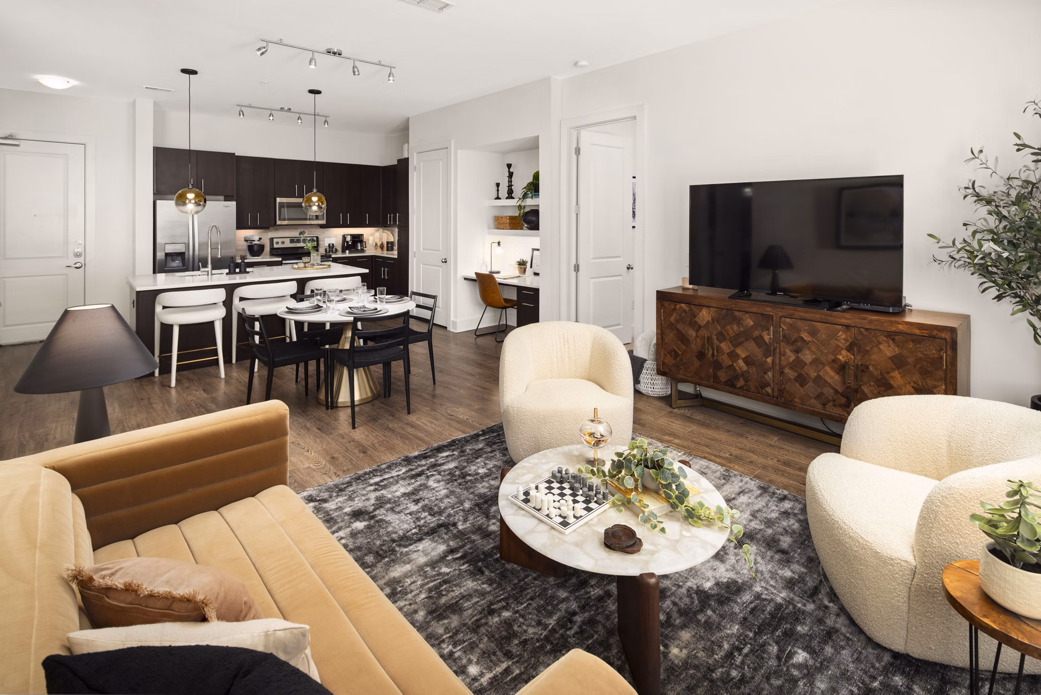 Spacious living room with modern decor and natural light in Tens on West Apartments