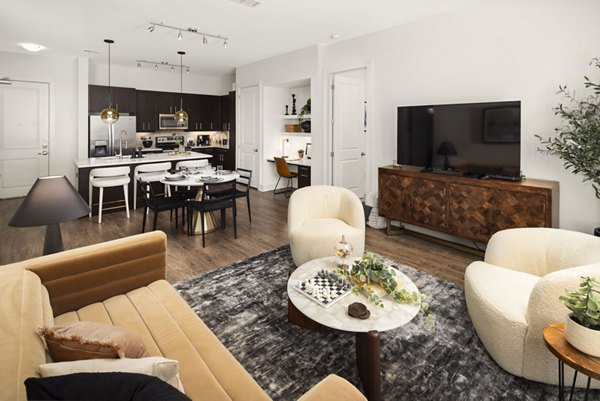 Spacious living room with modern decor and natural light in Tens on West Apartments