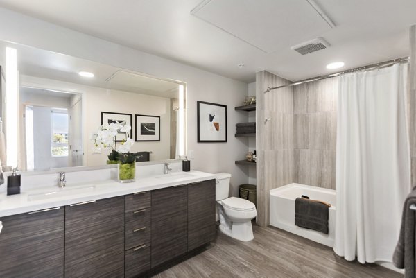 Modern bathroom with marble countertops and sleek fixtures at Valentina by Alta Apartments