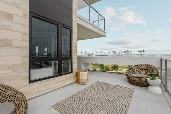Patio space with modern seating and ocean views at Valentina by Alta Apartments, ideal for relaxation and social gatherings