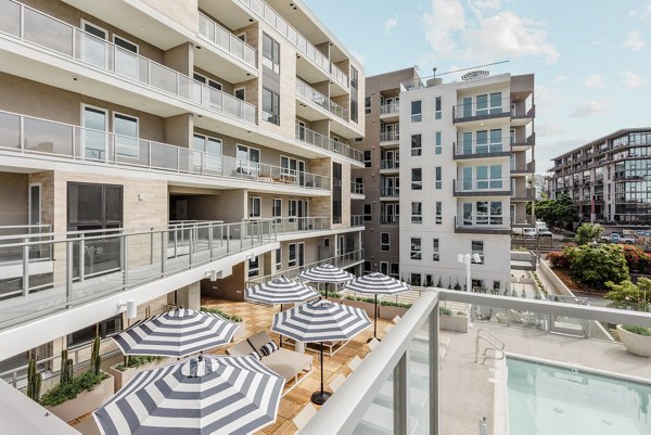 Patio with cozy seating and ocean views at Valentina by Alta Apartments