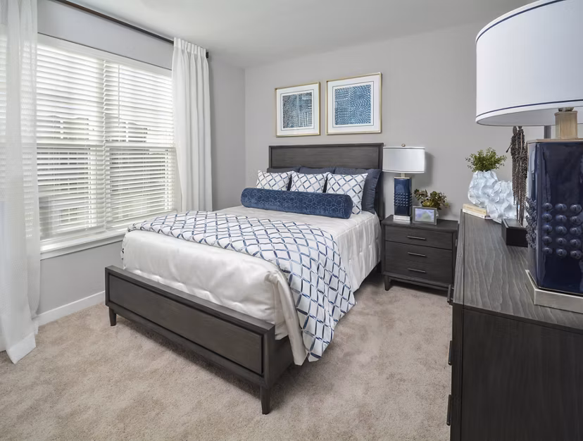 Bedroom featuring modern design and cozy comforts in The Wexley at 100 Apartments