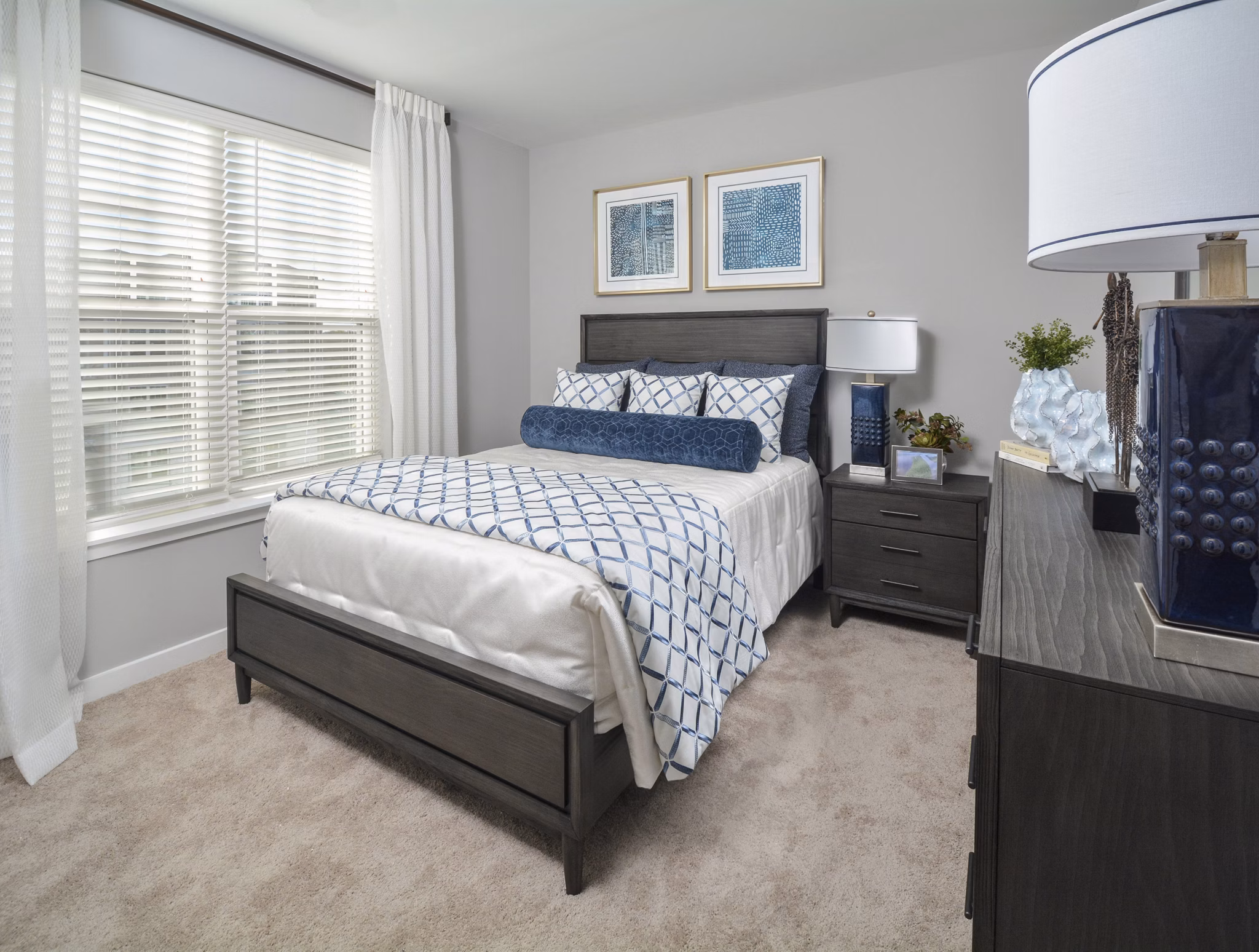 Bedroom featuring modern design and cozy comforts in The Wexley at 100 Apartments