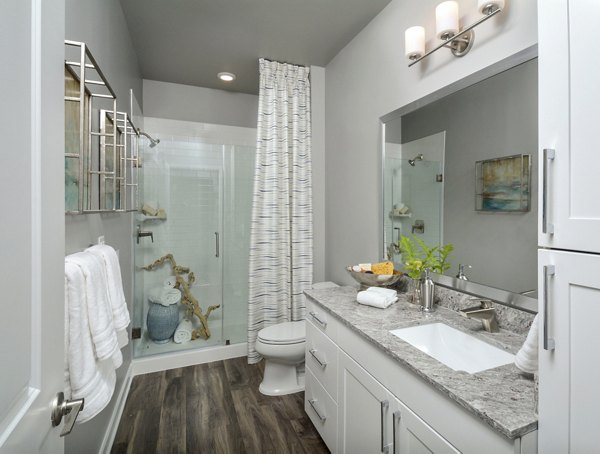 The Wexley at 100: Elegant bedroom with king-sized bed and large windows in luxury apartment