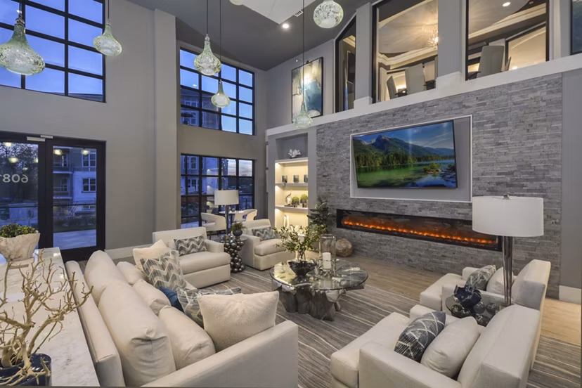 Modern clubhouse with cozy seating and entertainment options at The Wexley at 100 apartments