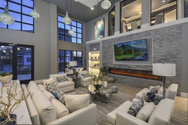 Modern clubhouse with cozy seating and entertainment options at The Wexley at 100 apartments