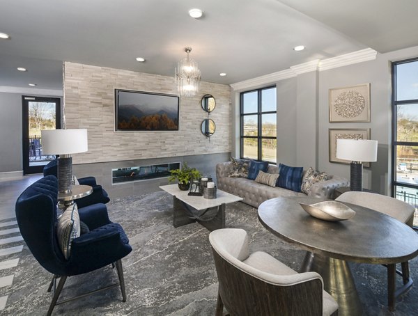 Modern clubhouse with plush seating and billiards at The Wexley at 100 Apartments