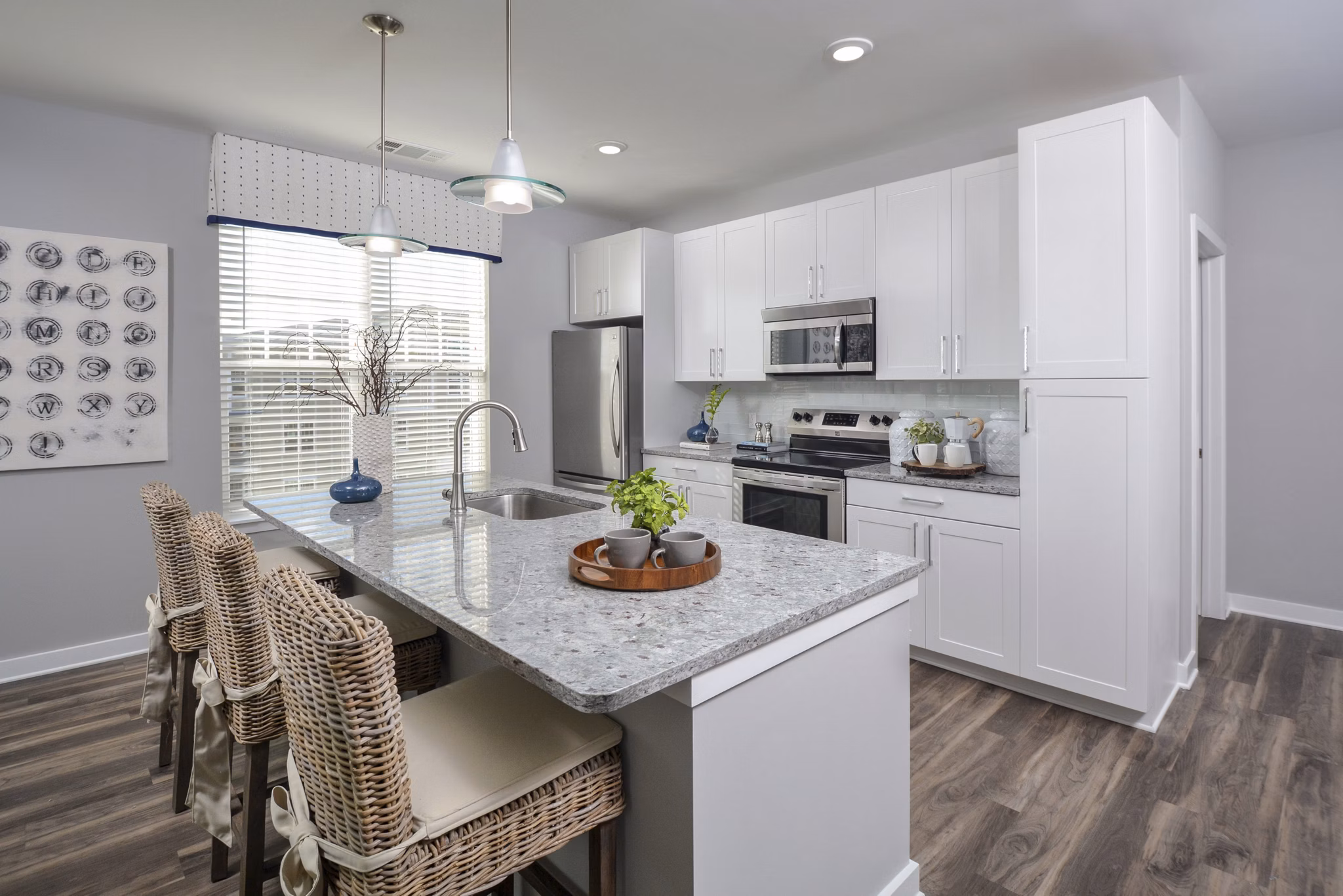Modern kitchen featuring stainless steel appliances at The Wexley at 100 Apartments