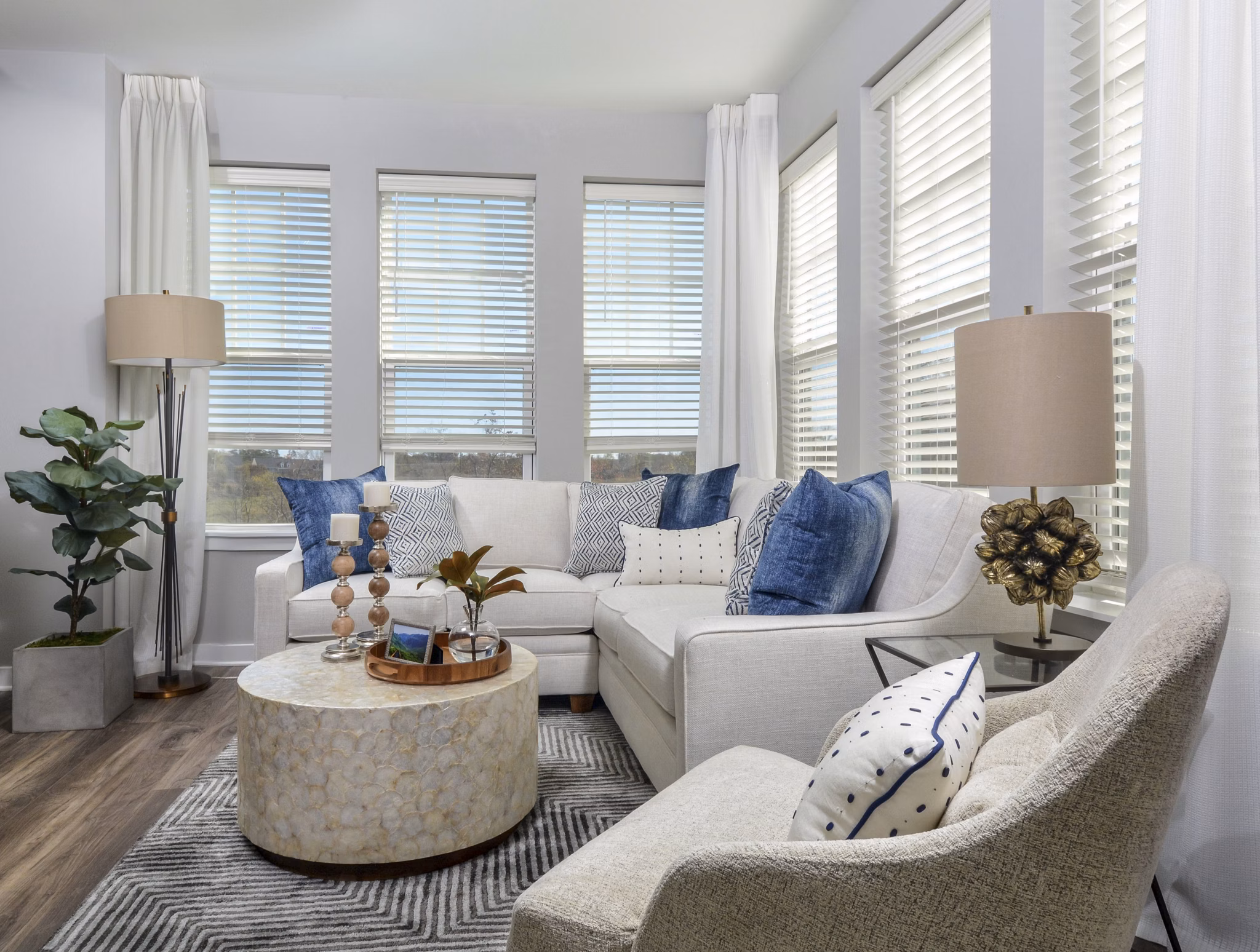 Spacious living room with modern furnishings at The Wexley at 100 Apartments, featuring luxury design and comfortable seating