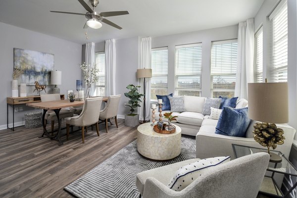 Spacious living room with modern decor in The Wexley at 100 Apartments