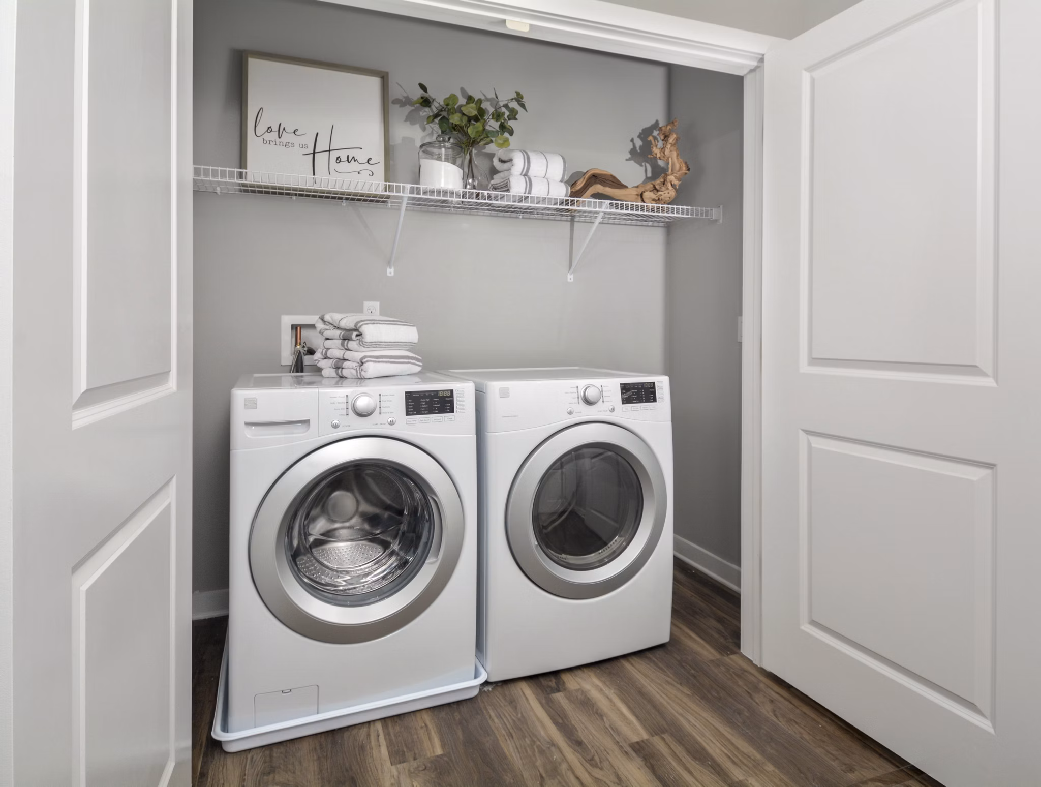 Efficient laundry room with modern appliances at The Wexley at 100 Apartments