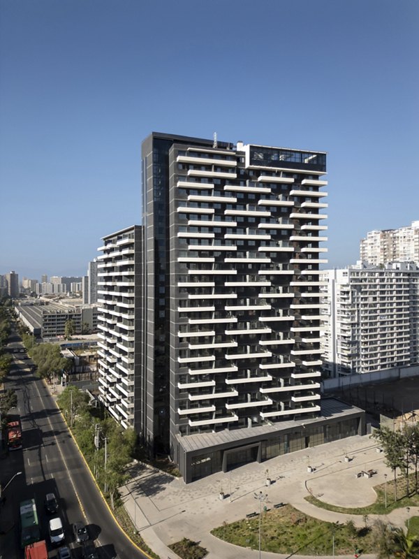 Modern high-rise building with balconies in a cityscape under a clear blue sky.