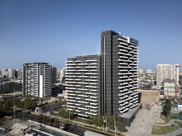 Two modern high-rise buildings in an urban setting under a clear blue sky.