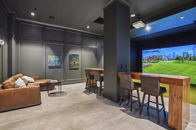 Game room with billiards and seating at The Lodge Apartments
