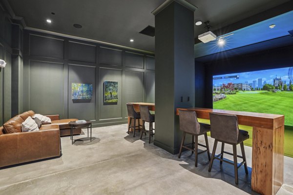 Game room with billiards and seating at The Lodge Apartments