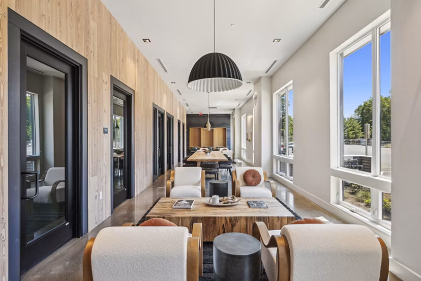 The Lodge Apartments: Modern clubhouse featuring a cozy fireplace and lounge seating