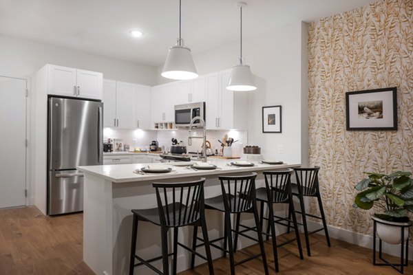 kitchen at The Lodge: Modern kitchen with stainless steel appliances and granite countertops in Greystar's The Lodge Apartments