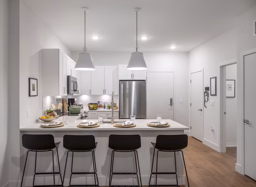 Modern kitchen with stainless steel appliances at The Lodge Apartments