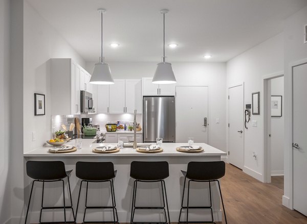 Modern kitchen with stainless steel appliances at The Lodge Apartments