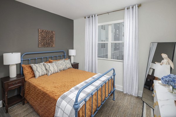 Cozy bedroom with modern decor at The Clara by Broadstone Apartments
