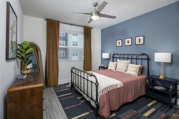 Serene bedroom with modern furnishings at The Clara by Broadstone Apartments