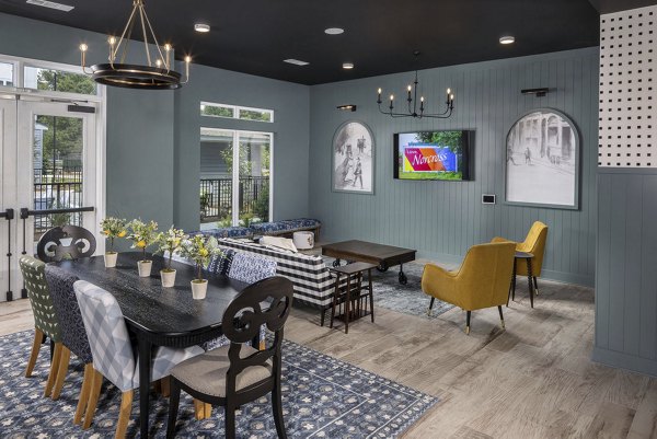 Stylish clubhouse with modern furnishings at The Clara by Broadstone Apartments, perfect for residents' social gatherings and events