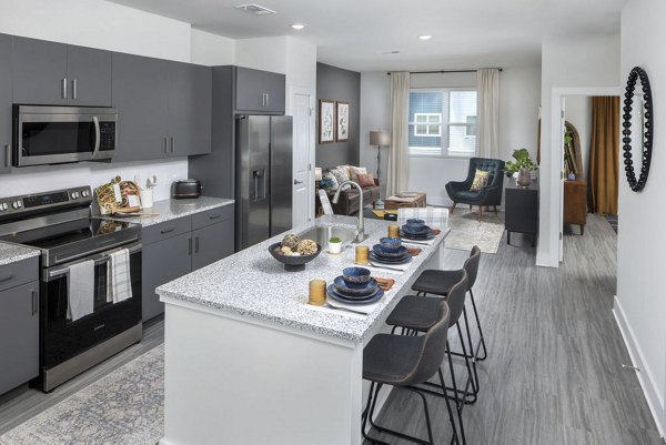 Modern kitchen with stainless steel appliances at The Clara by Broadstone Apartments