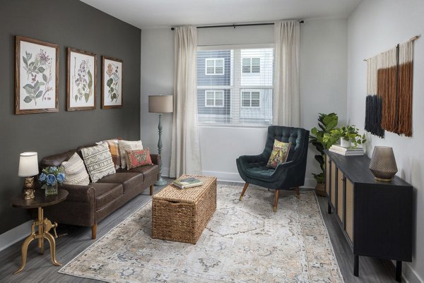 Spacious and modern living room at The Clara by Broadstone Apartments featuring natural light and contemporary furnishings