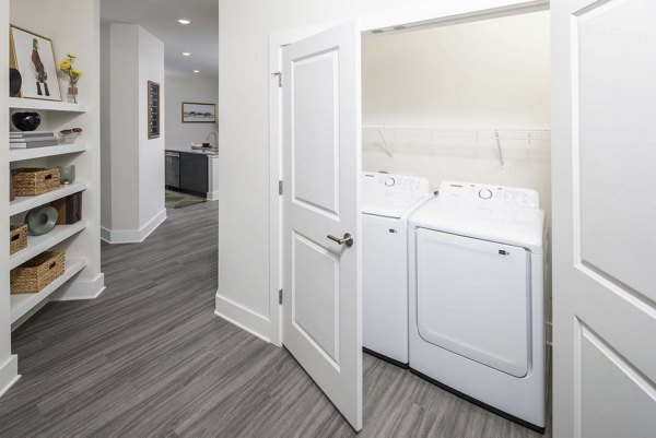 Laundry room featuring modern appliances at The Clara by Broadstone Apartments