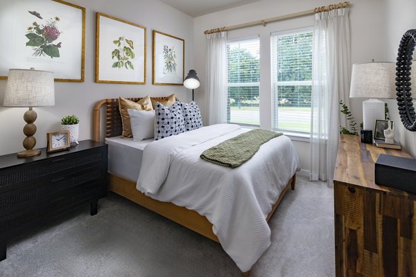 Bedroom featuring modern design and natural light at Flats at General Time Apartments