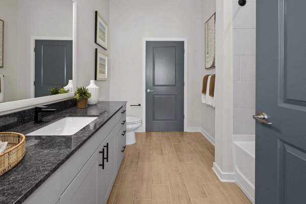 Bathroom featuring modern fixtures and sleek design at Flats at General Time Apartments