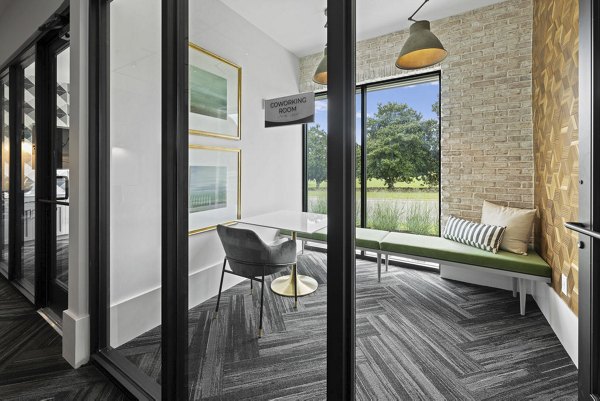 Home office space featuring modern desk and ergonomic chair at Flats at General Time Apartments