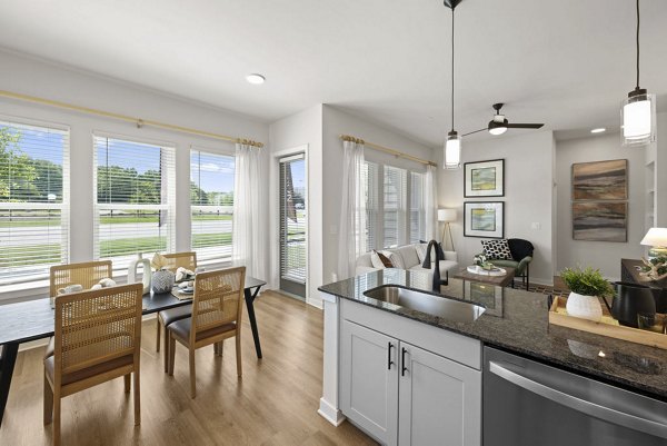 Modern kitchen featuring stainless steel appliances and quartz countertops at Flats at General Time Apartments